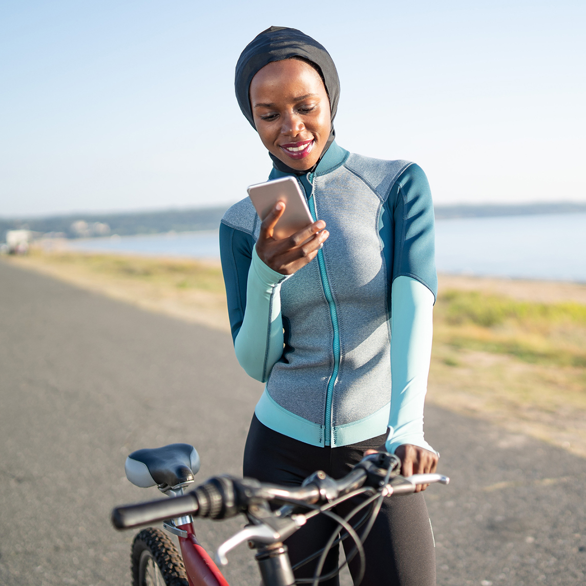 Woman using cell phone on bike ride