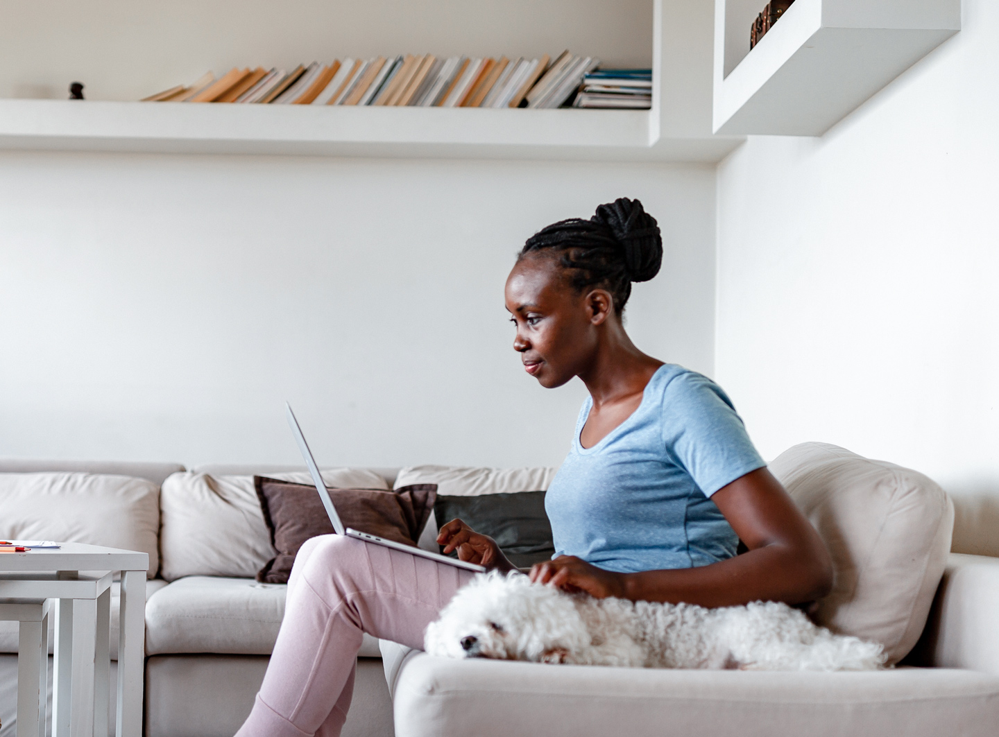 woman using CenturyLink internet to check her email on her couch