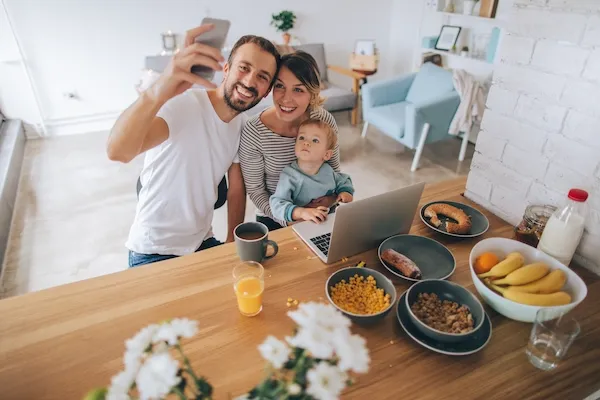 young family taking picture at breakfast