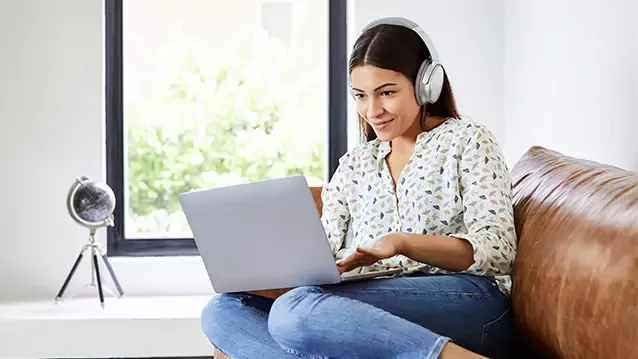 young latina woman using laptop at home