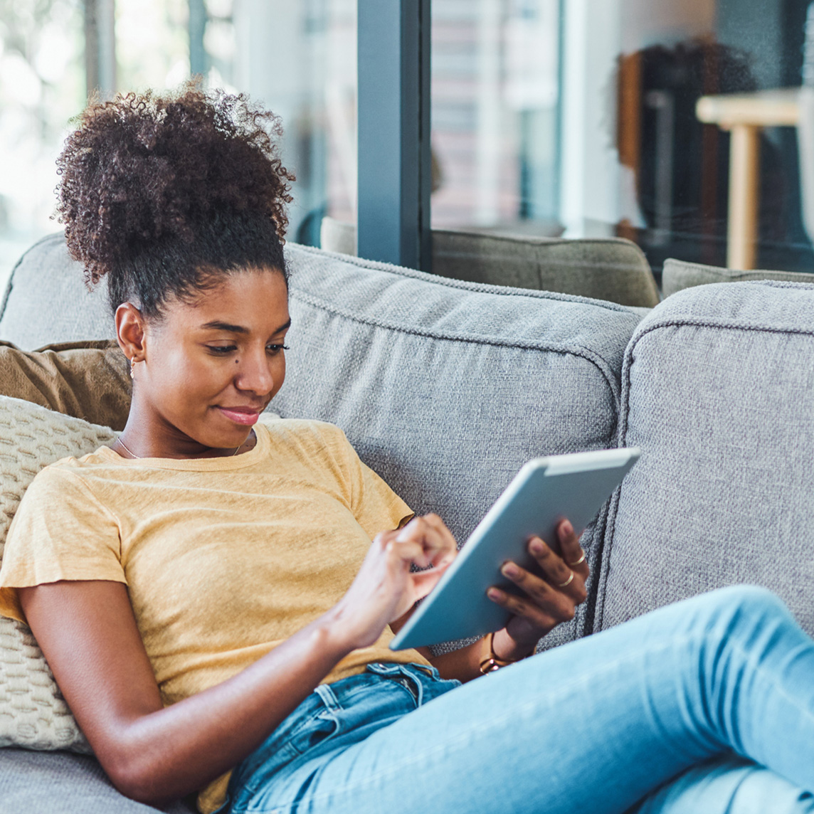 Young adult reading on ipad