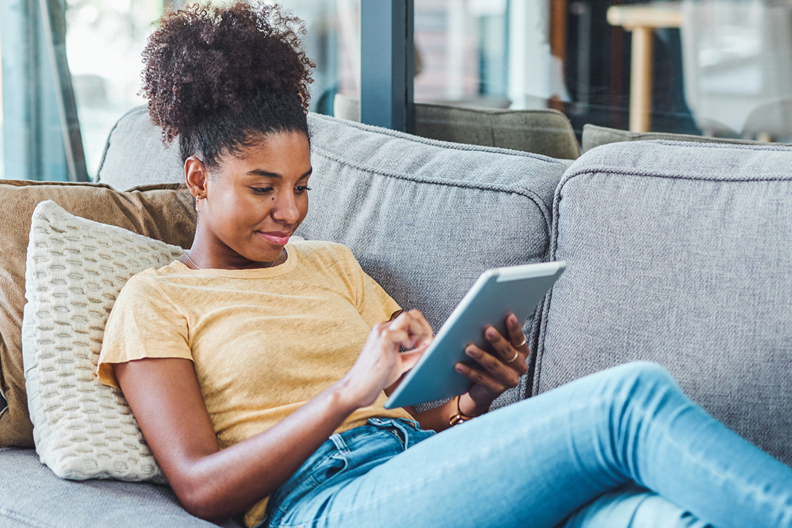 Young adult reading on ipad