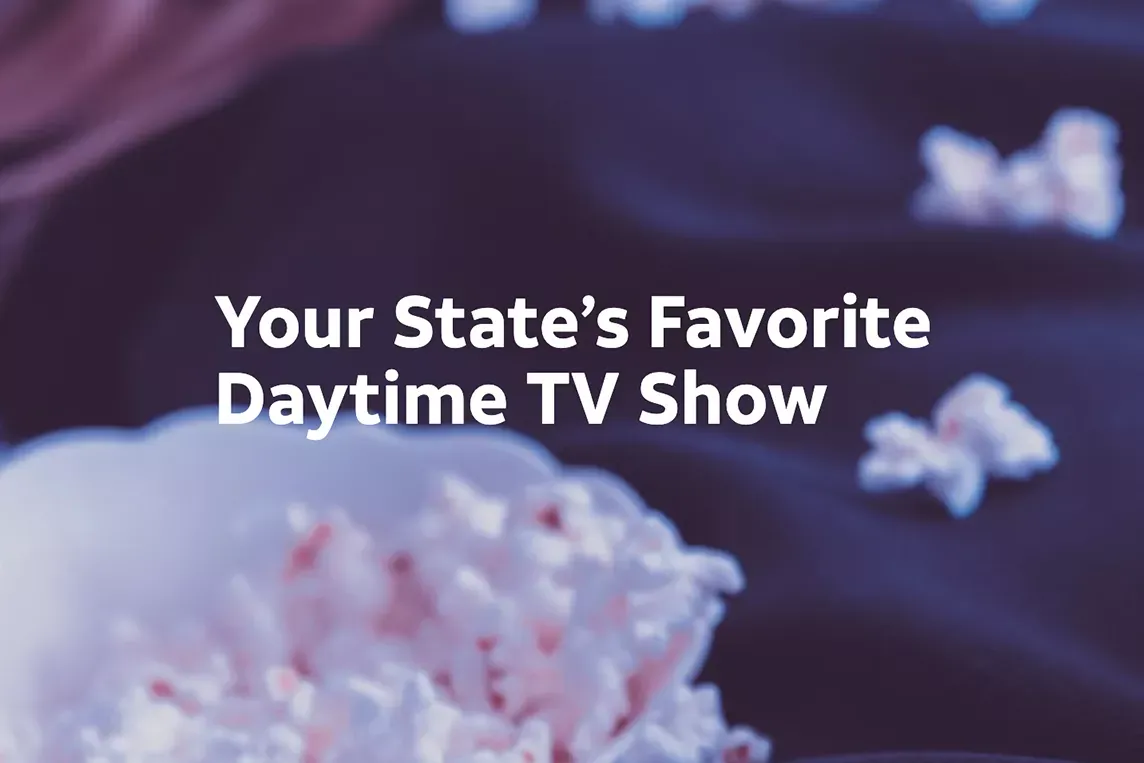 Woman eats popcorn while watching TV