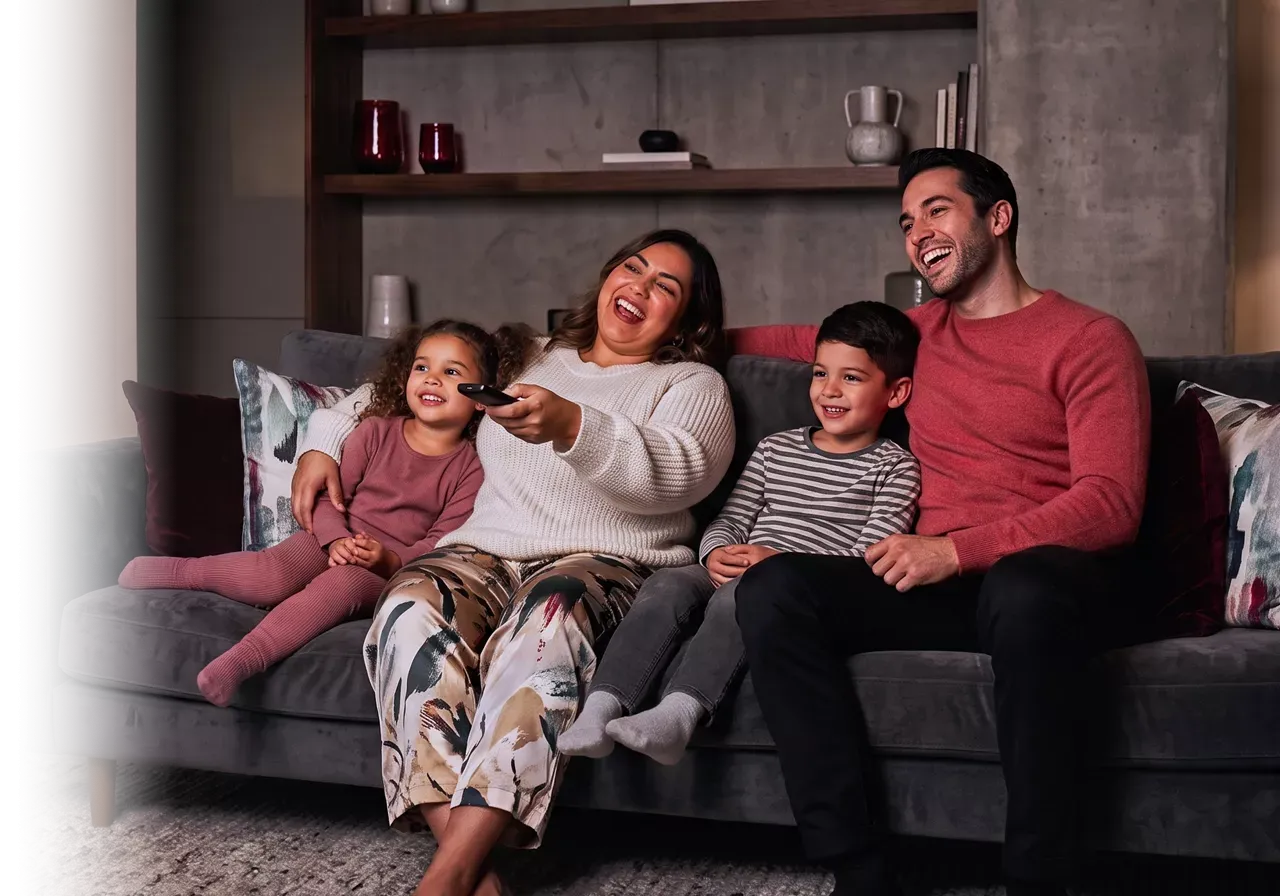 Happy family enjoying their favorite TV show.