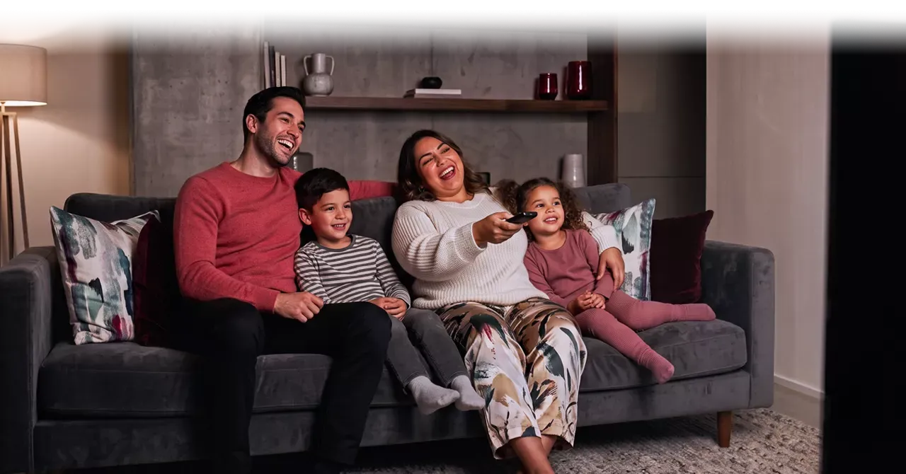 Happy family enjoying their favorite TV show.